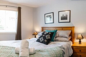 Comfortable bedroom with lots of natural light.