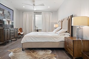 master bedroom that features king-sized bed