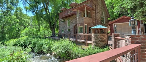 View of creekside home from bridge 