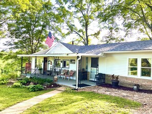 Deck, covered porch, picnic area, flower beds and large yard