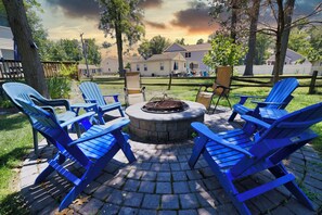 Fire pit in large back yard.  Burning wood is provided. 