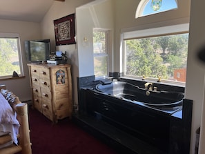 Delightful 2-person whirlpool bathtub and aspen chest in MBR loft.