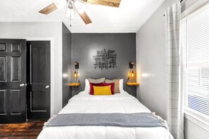 Retreat to tranquility in the Master Bedroom, Featuring a Queen-Sized Gel Memory Foam Bed and Serene Amber Lighting for an Atmosphere of Relaxation.