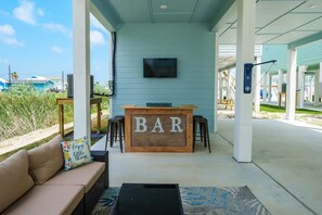 Outdoor entertaining area. Complete with outdoor bar and barstools, TV and patio seating. 