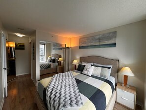 Master bedroom has a queen size bed, 2 mirror closets and double blinds/curtain.