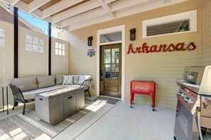 Out back on our covered patio, you'll have access to our lounge area, gas fire pit, vintage Coca-cola ice chest, grill and string lights.