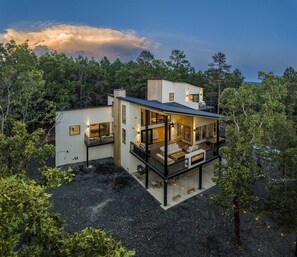 Exterior Retreat: Embrace nature from a stylish outdoor deck with stunning forest views!