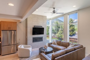 Living area offering a gas fireplace, mountain views and cozy furnishings.