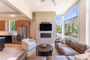 Living area offering a gas fireplace, mountain views and cozy furnishings.