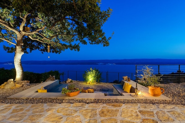 Lounge corner with an oak tree shade and spectacular sea views, which makes this a perfect spot for a glass of vine.