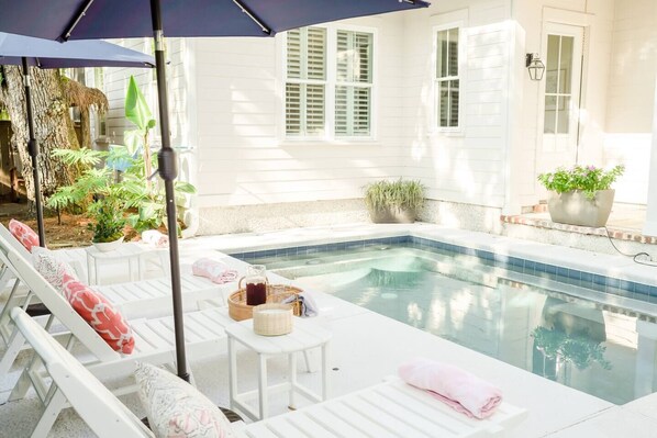 Beautiful pool with chaise lounges and umbrellas.