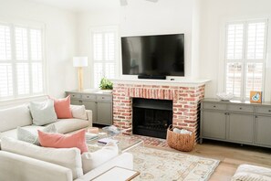 Living room with large sectional and smart TV.