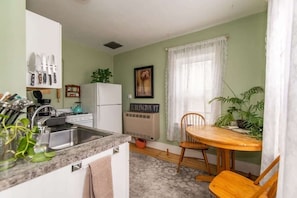 Bright, welcoming kitchen fully equipped with everything one would need. A selection of coffee and tea is provided for guests.