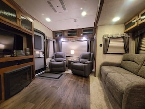 Living Area with Recliners, Fireplace, and Queen Size Futon for additional Guest