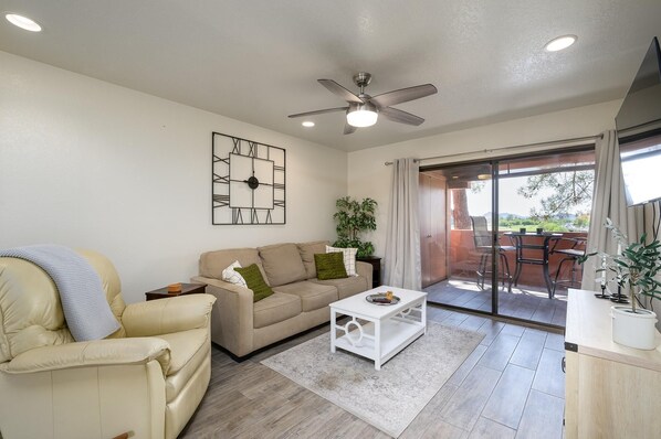 Living room has sofa bed and leather recliner.