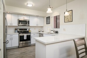 Fully stocked kitchen with quartz counter tops.