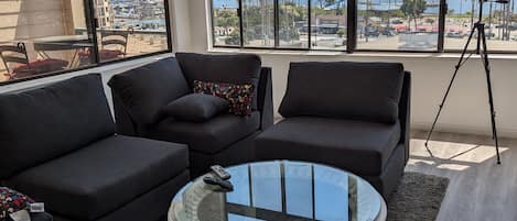 Living room with cathedral ceiling.180 degree ocean view with deck. 86 in. tv