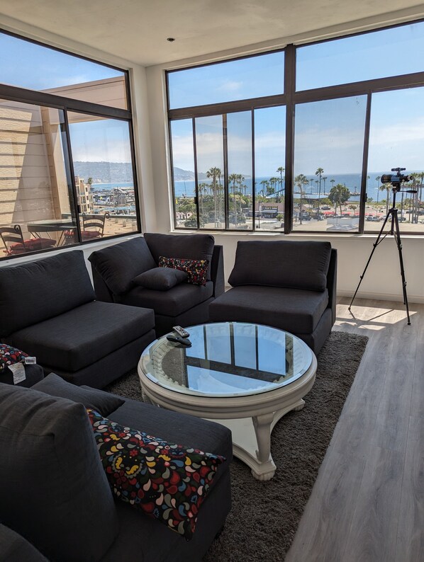 Living room with cathedral ceiling.180 degree ocean view with deck. 86 in. tv