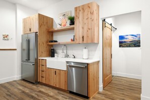 Kitchen area and hallway with bathroom door