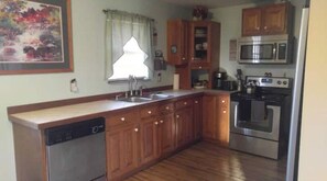full kitchen, dishwasher, microwave,  stove/oven, full refrigerator w/ ice maker