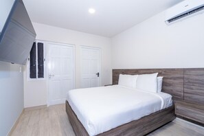 This bedroom features a queen sized bed and its own private bathroom.