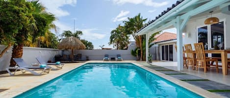 Enjoy your day with this crystal blue outdoor swimming pool.