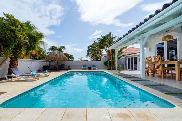 Enjoy your day with this crystal blue outdoor swimming pool.