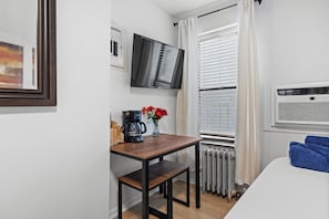 Versatile table with seating for two, ideal for meals or remote work.