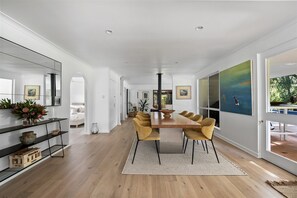 Gather for shared meals in the stylish dining area beside a fully equipped country-style kitchen.