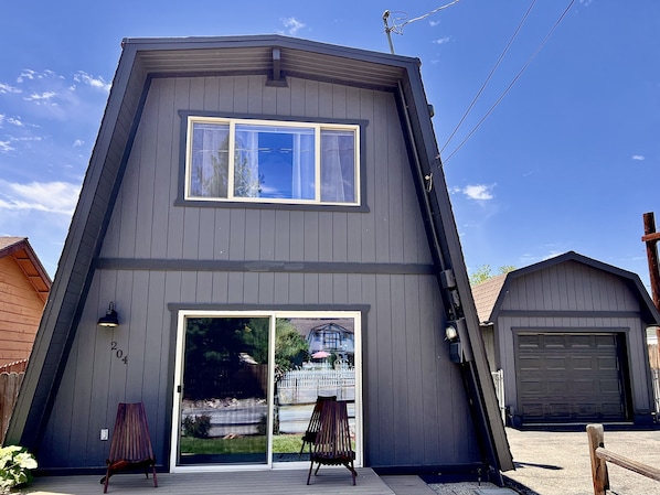 Modern Modified A-Frame Cabin showing front open porch with modern chairs