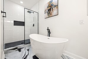Spa-style primary ensuite bathroom features a standalone soaking tub and a large shower.