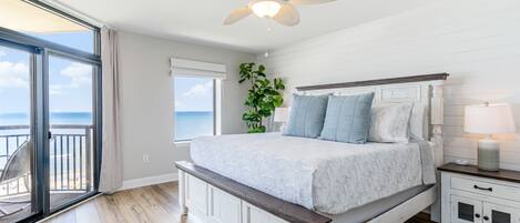 Primary oceanfront bedroom with sliding door to balcony