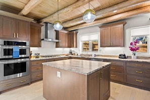 Chef's Kitchen with oversize island, double oven, deep sinks (main level)