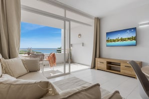 Pleasant and bright living room with sofa bed, a Smart TV and access to the balcony