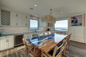 Large custom-made dining table. Wet bar, drink fridge & coffee station.