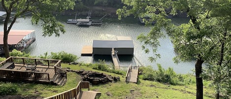 Private dock with paddle boat, paddle board, 2 kayaks, and one boat slip.