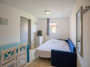The living area features a double sofa bed.