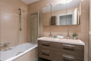 Bathroom with shower and bathtub