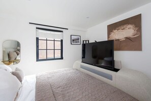 The master bedroom has a TV bed frame.