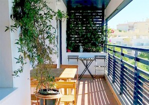 Sunny balcony with outdoor dining space for six guests and lovely views