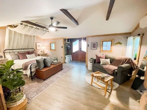 The cabin interior includes a cozy, romantic bedroom and living area.