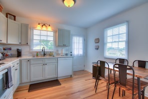 The spacious, fully equipped kitchen is ready for your cooking creativity. Make those tasty meals and serve them at the adjacent dining table.