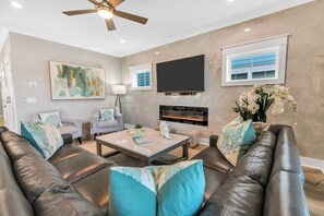 Luxurious family room features custom tiled wall with fireplace and contemporary coastal details in our  top rated vacation rental on Hilton Head Island, SC!