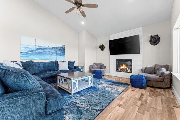Ample seating, large Smart TV, and cozy electric fireplace in the main floor living room