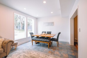 Dining area #1 with large windows with plenty of light.