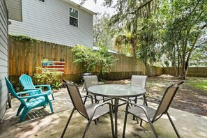 An expansive backyard with a BBQ and outdoor seating