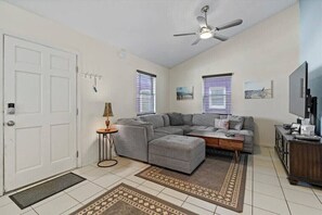 A bright and spacious sitting area with a large plush sofa