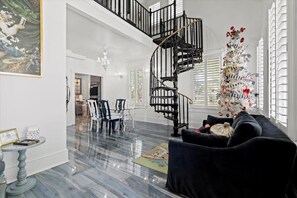 The spiral staircase will lead you to the upper level of the home