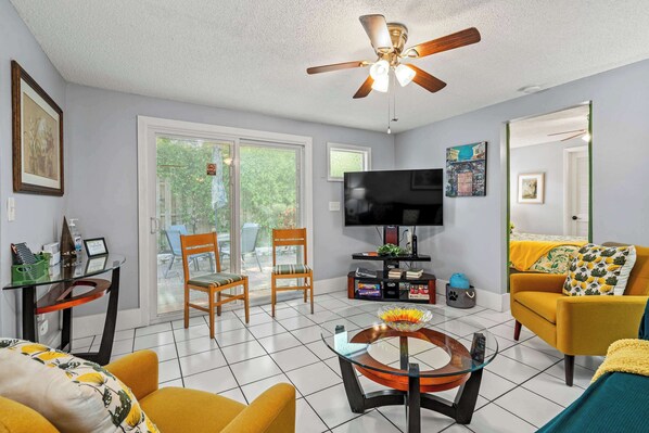 A luminous sitting area with plush seating that faces a large TV, providing a relaxing space to hang out