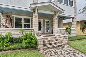 Our expansive front porch has several comfy hangout sections. It's fun to relax here with a drink and watch the neighborhood activities going to and fro, hither and thither.